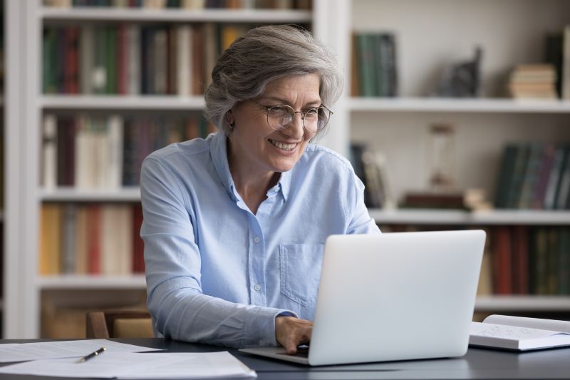 Woman Using Computer to Book Appointment Covered California Online 