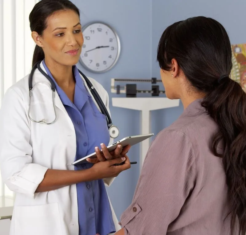 Female Doctor Consulting Patient about PPO health insurance