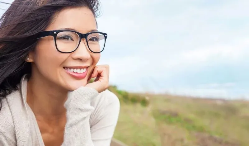 Smiling Woman with Glasses, Representing Dental and Vision Insurance