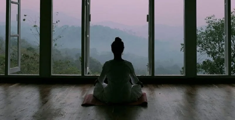 Woman doing yoga at home, serene with mental health resources
