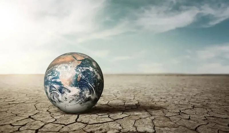 Illustration of Earth on parched land, symbolizing climate change impact